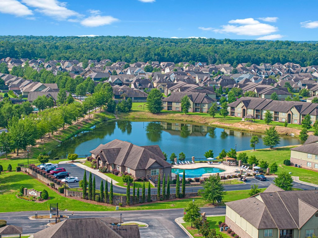 an aerial view of a community with a lake and houses