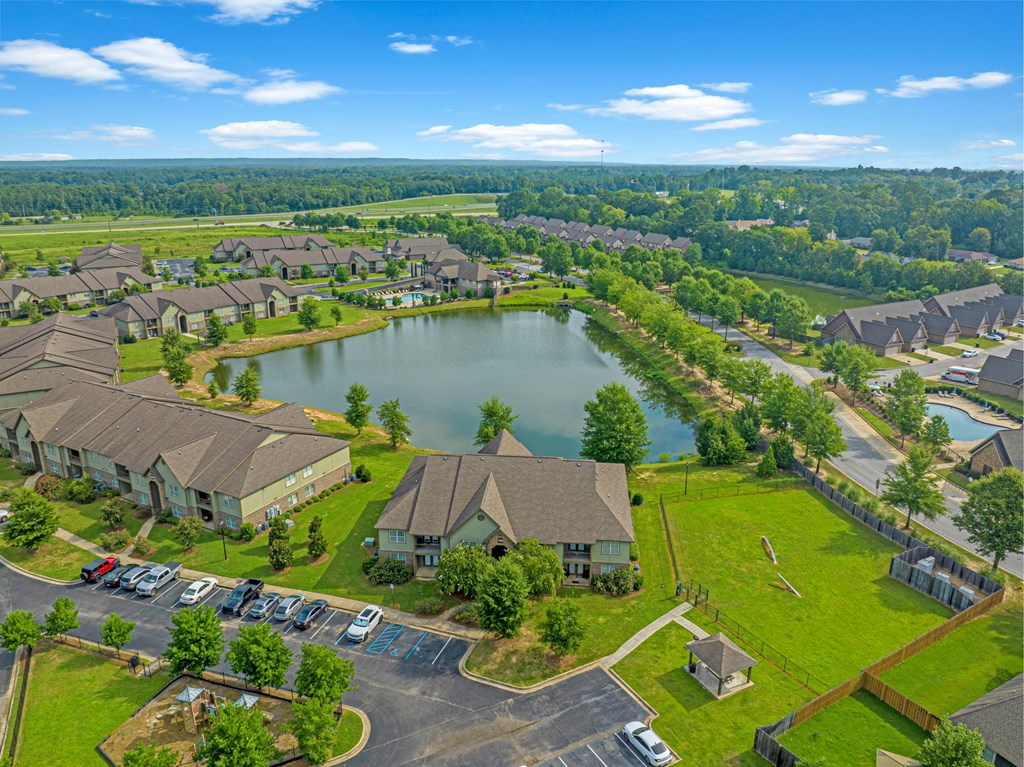 an aerial view of a community with a lake and houses
