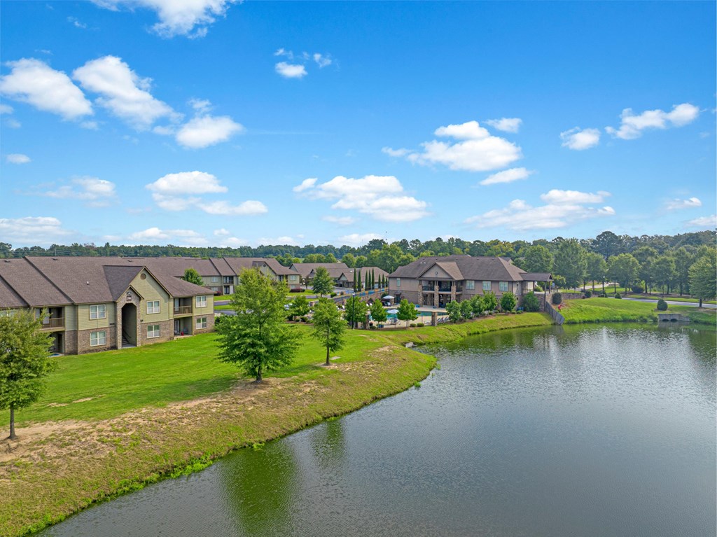 an aerial view of a river with houses next to it