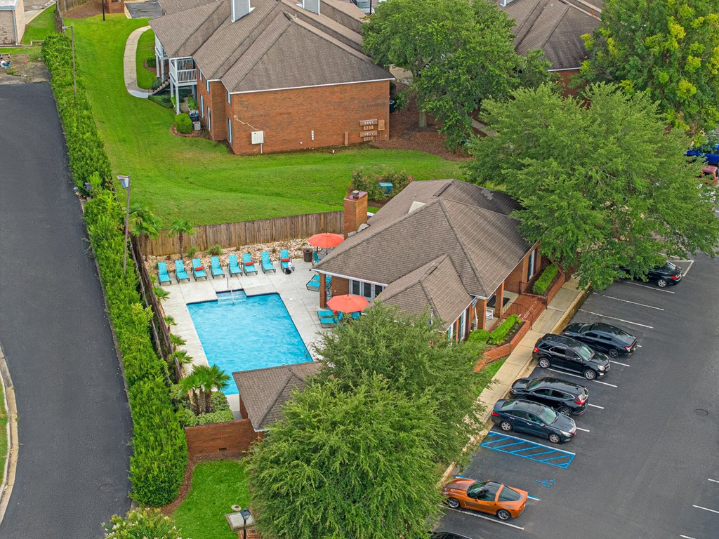 a house with a swimming pool and a parking lot