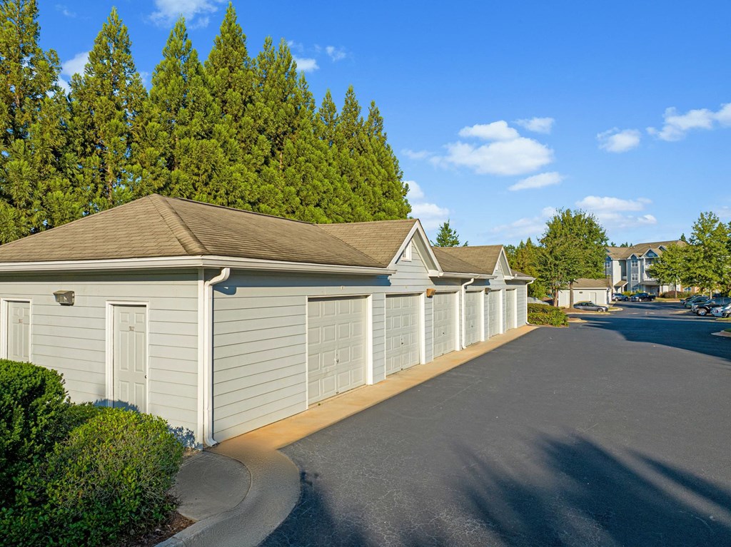 a row of white garages in a parking lot