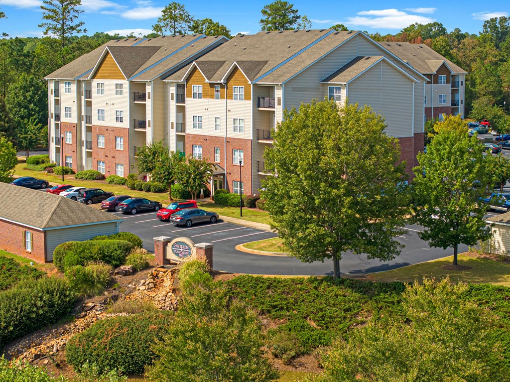 an aerial view of an apartment building with a parking lot