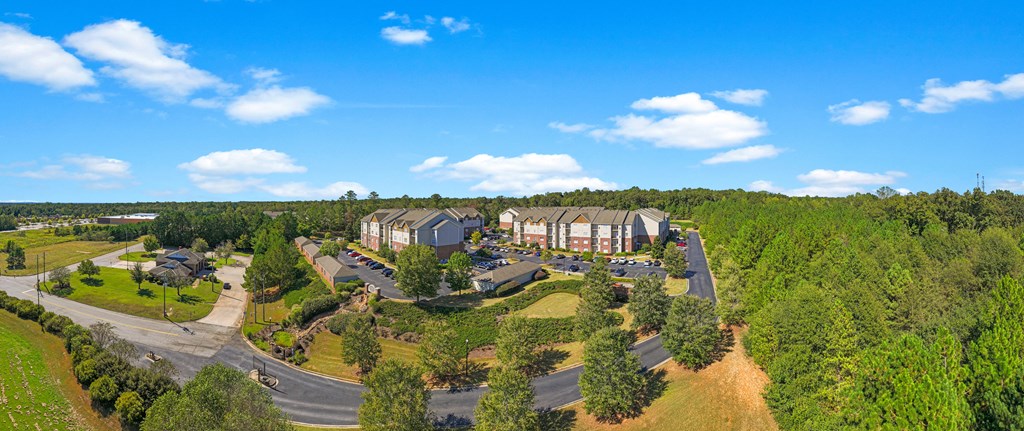 an aerial view of a resort with trees and houses