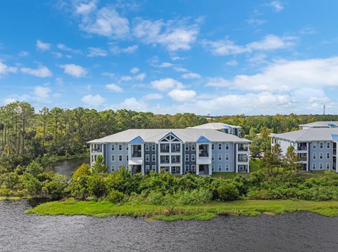 a large building with a river in front of it