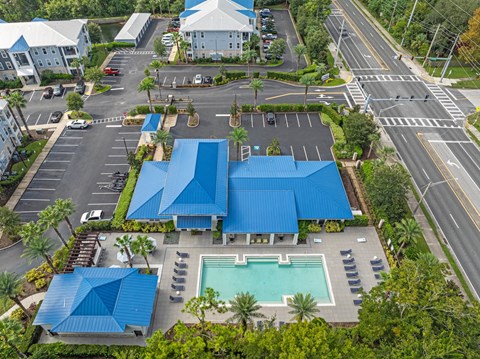 an aerial view of a building with blue roofs
