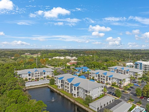 an aerial view of an apartment complex with a body of water