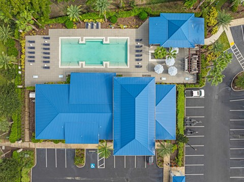 a birds eye view of a swimming pool with a blue roof