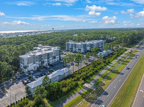 an aerial view of apartment buildings on the side of a road