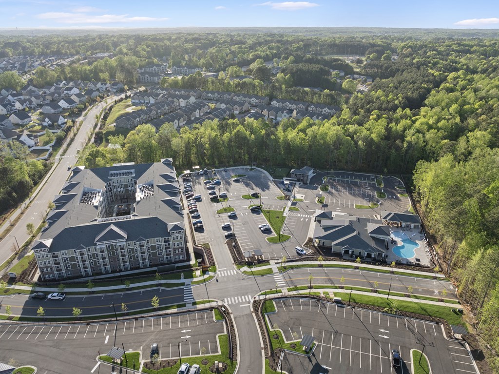 A large building with a parking lot in front of it.