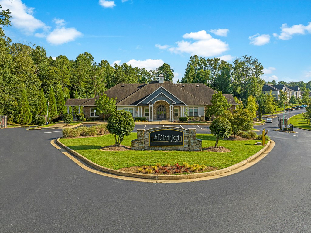 a large house with a driveway and a sign in front of it