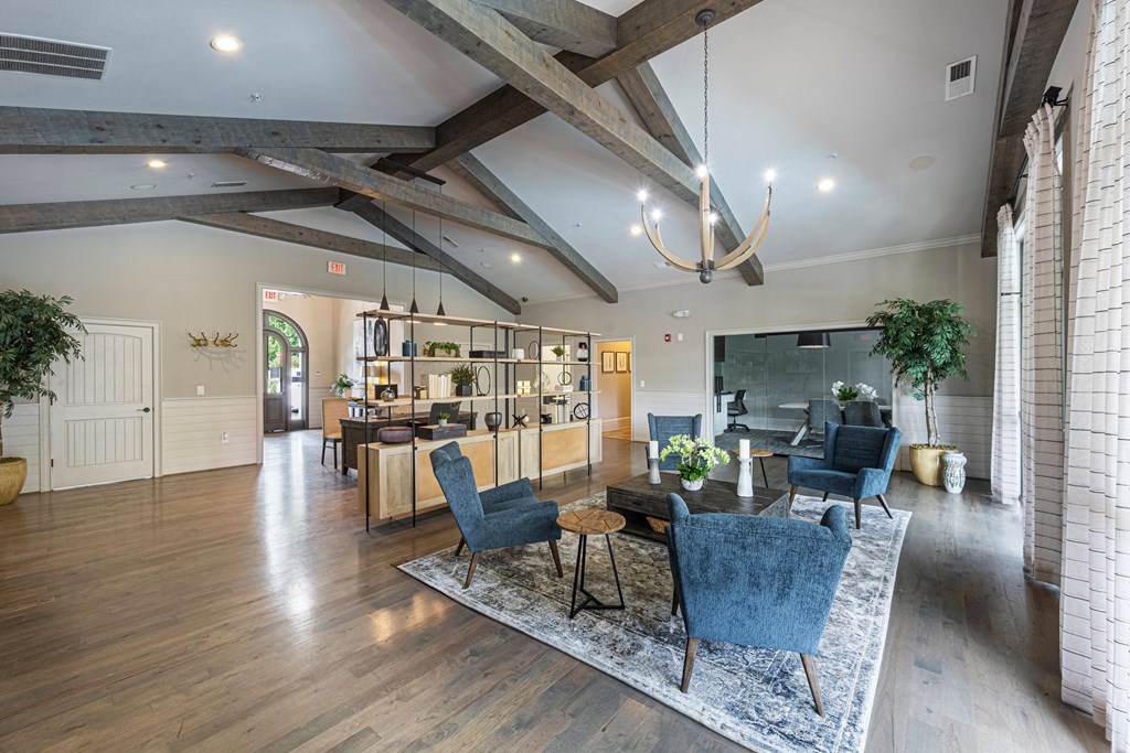 a living room with a dining room table and chairs