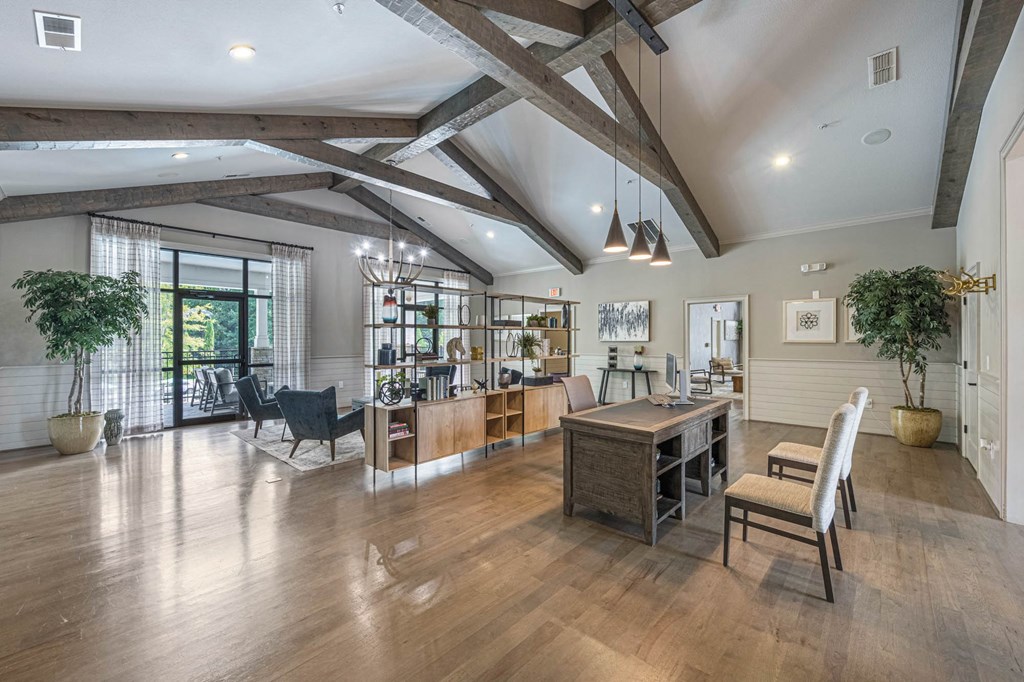 a large living room with exposed beams and a dining room table