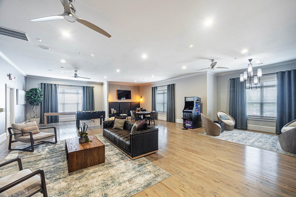 a living room with couches and chairs and a tv
