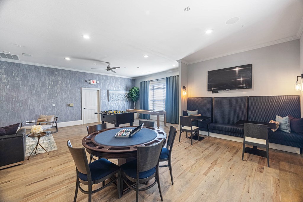 a living room with a round table and a couch and a tv