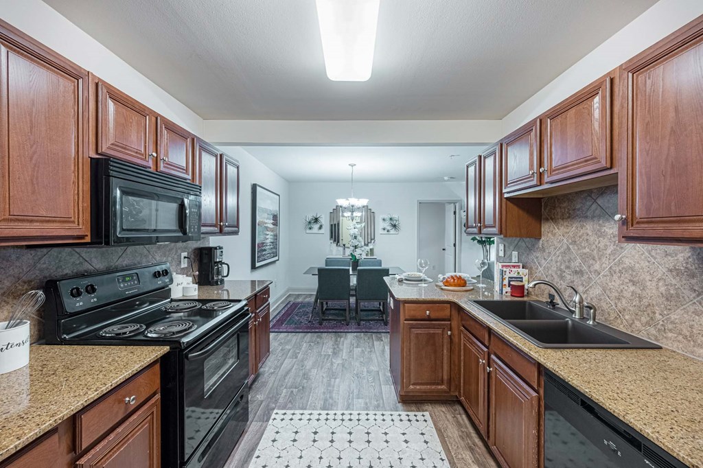 a kitchen with wooden cabinets and black appliances
