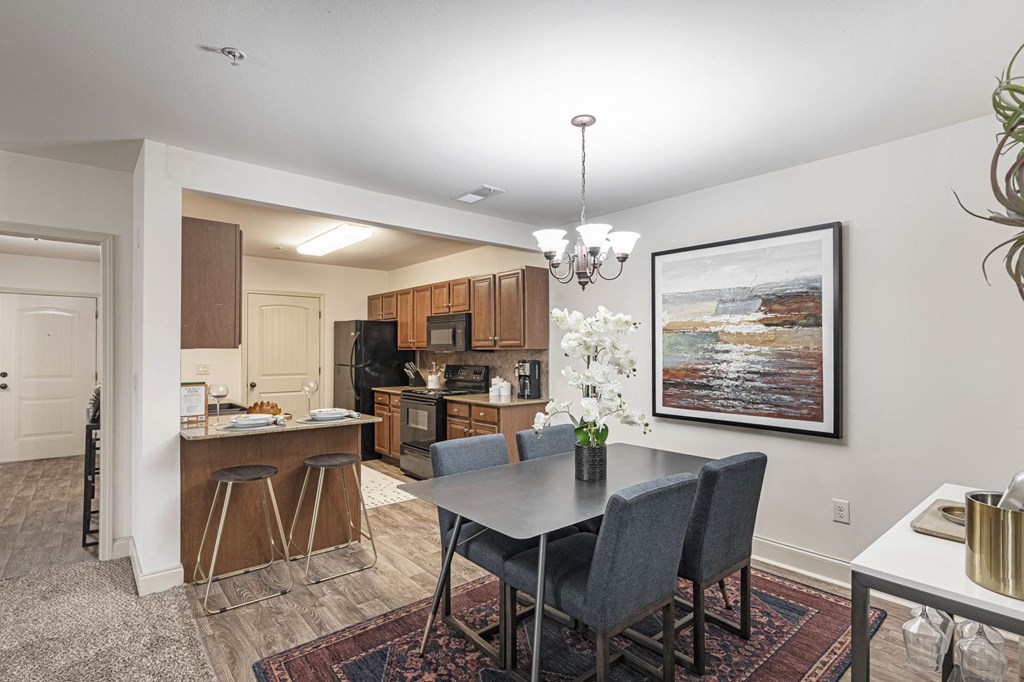 a kitchen and dining room with a table and chairs