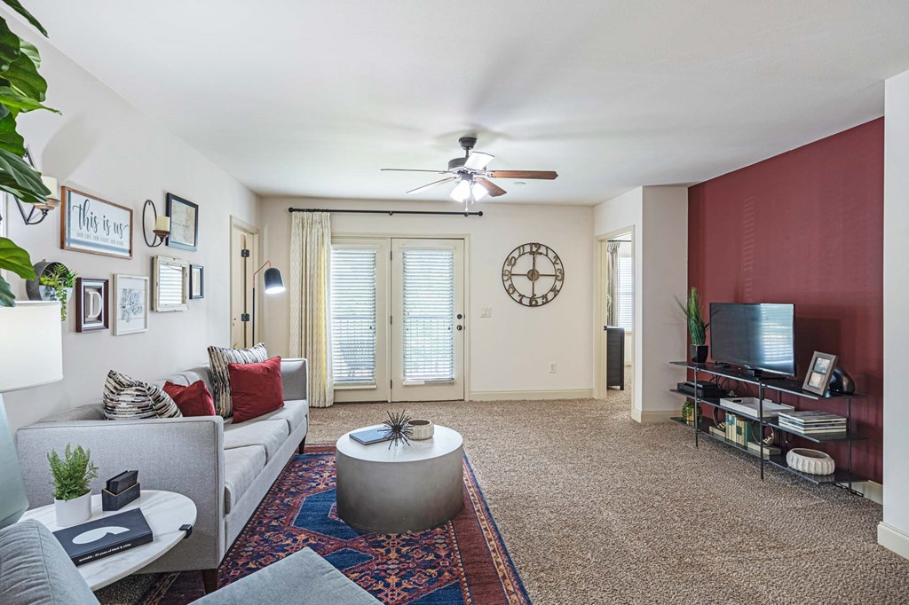 a living room with a couch and a ceiling fan