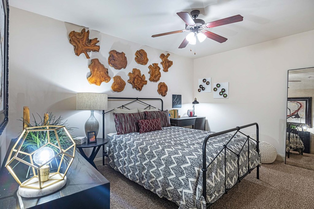 a bedroom with a bed and a ceiling fan