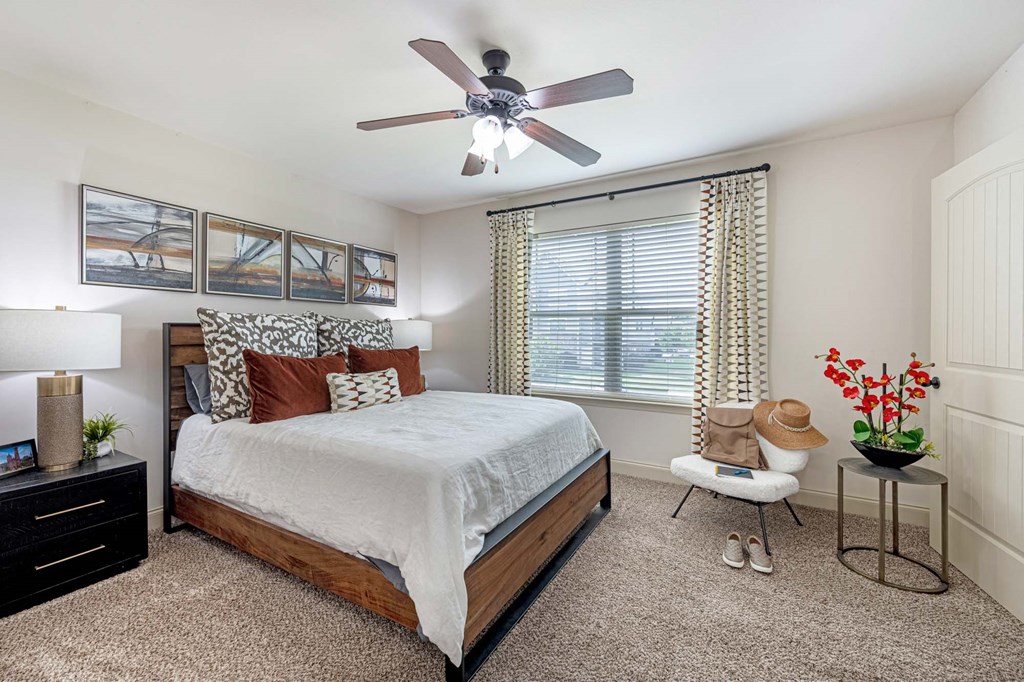 a bedroom with a bed and a ceiling fan