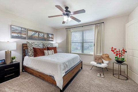 a bedroom with a bed and a ceiling fan