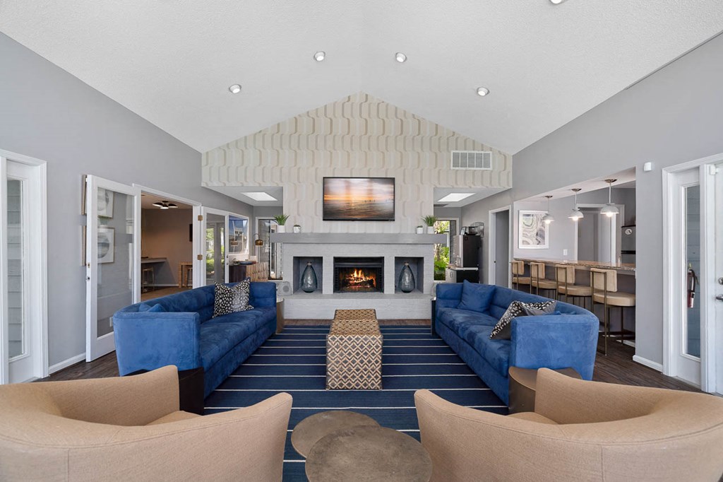 a living room with blue couches and a fireplace