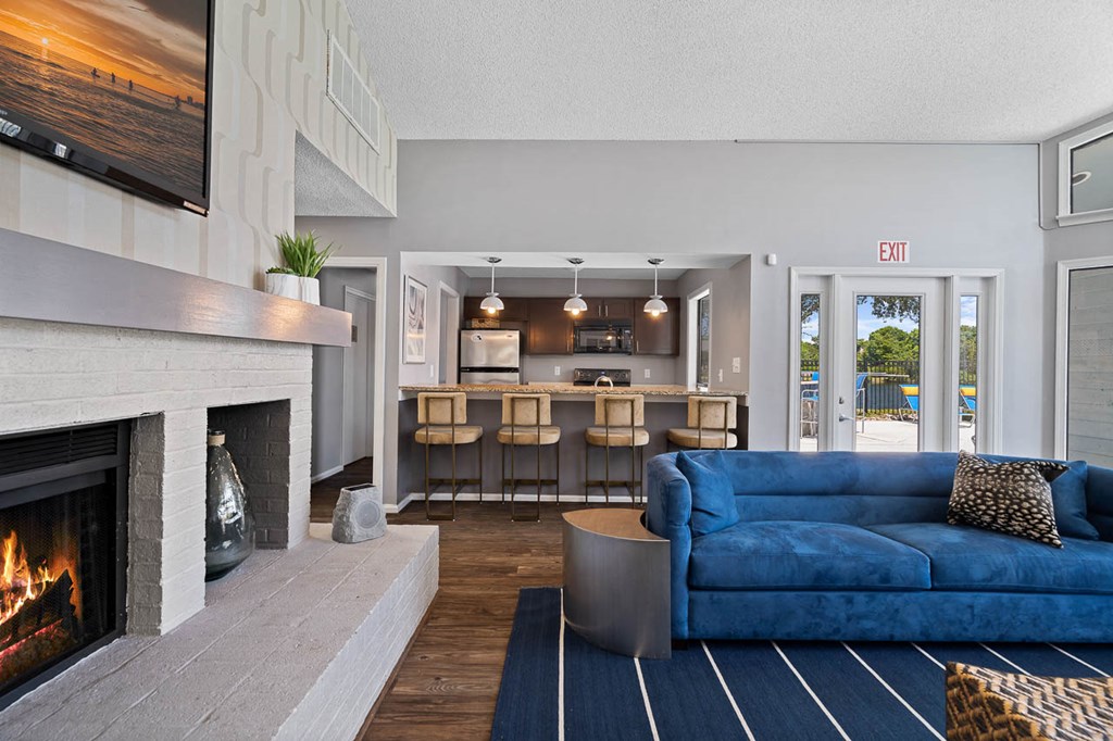a living room with a fireplace and a blue couch