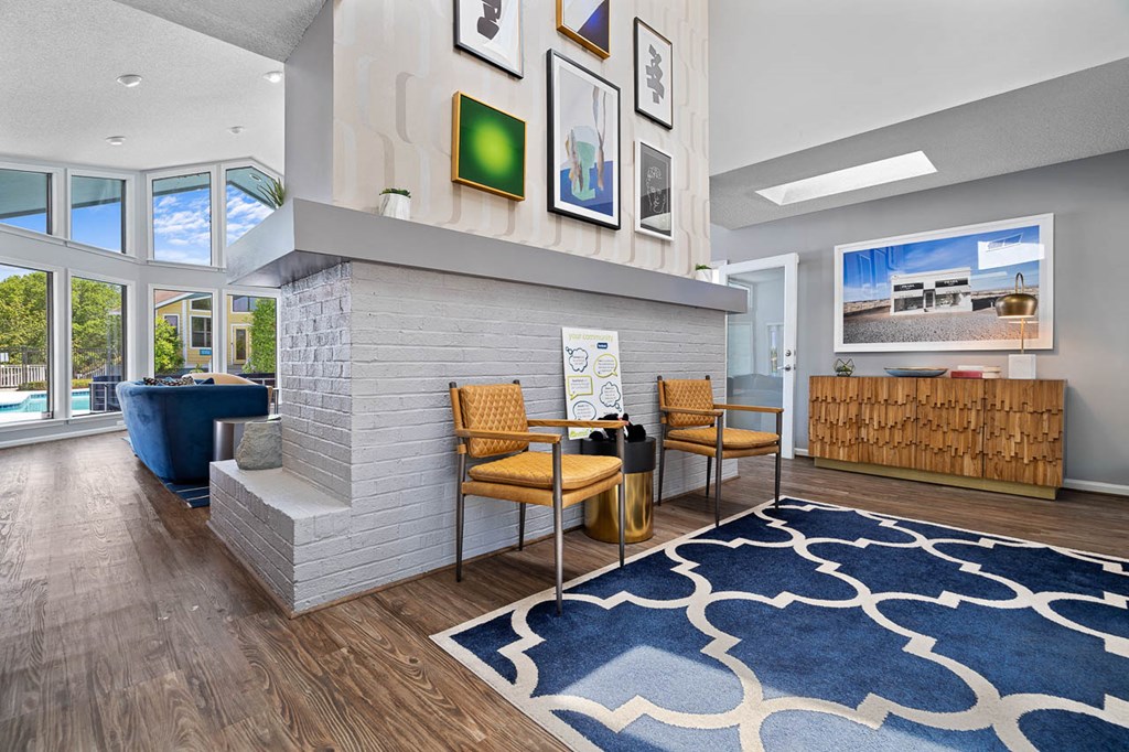 a living room with a fireplace and a blue rug