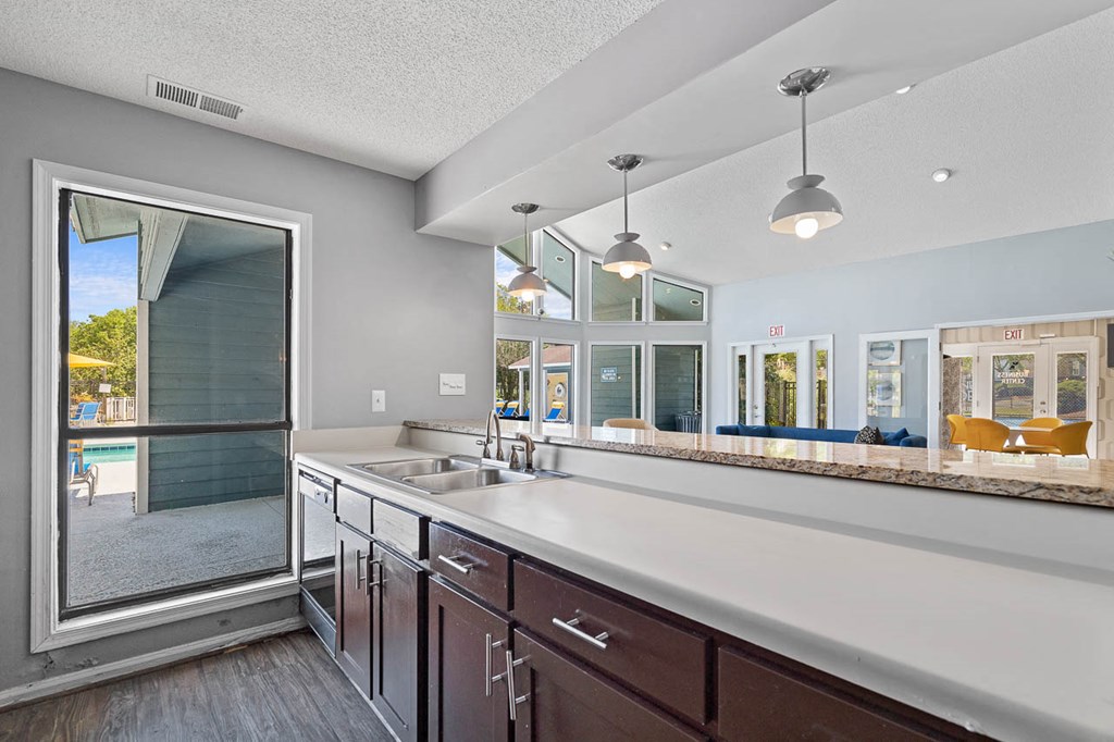 a large kitchen with a large window and a sink