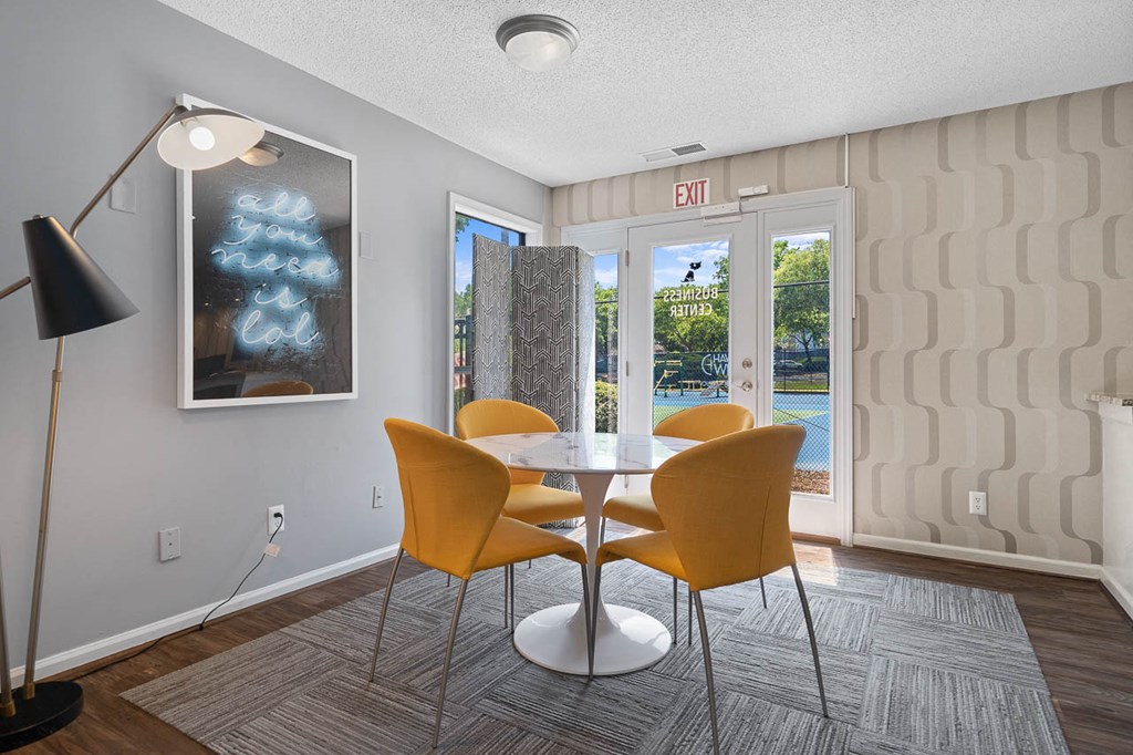 a dining room with a table and chairs and a door to a patio