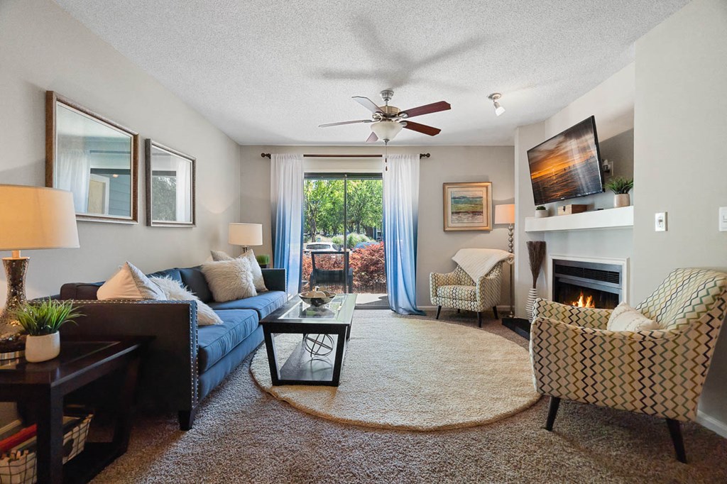 a living room with a couch and a ceiling fan