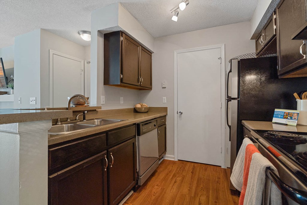 a kitchen with a sink and a refrigerator
