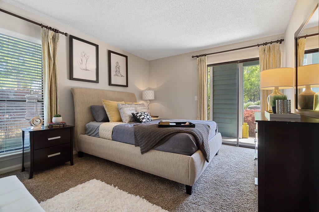 a bedroom with a bed and a large window