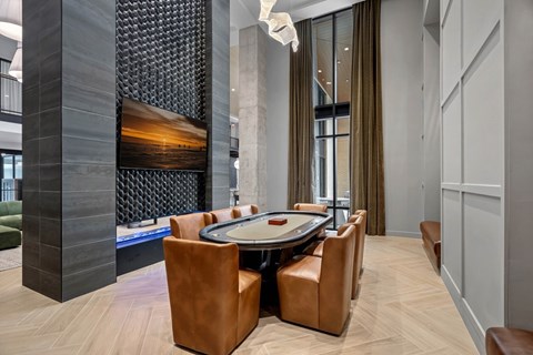 A modern dining room with a large table and chairs.
