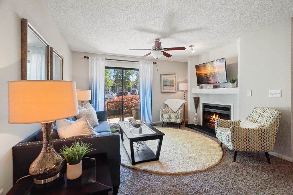 a living room with furniture and a ceiling fan