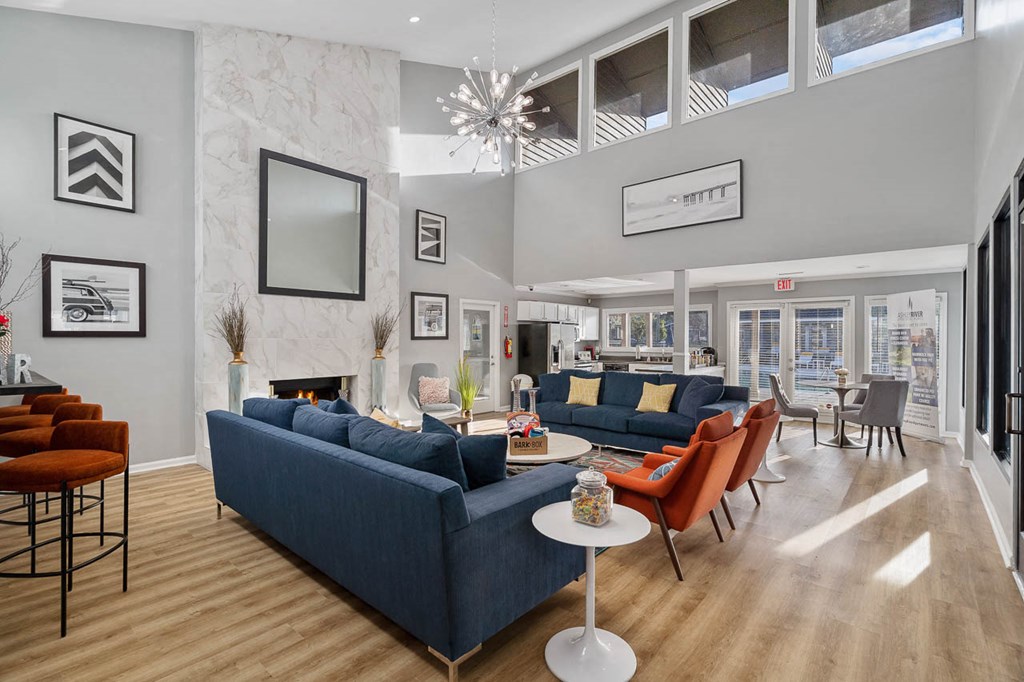 a living room with couches and chairs and a fireplace