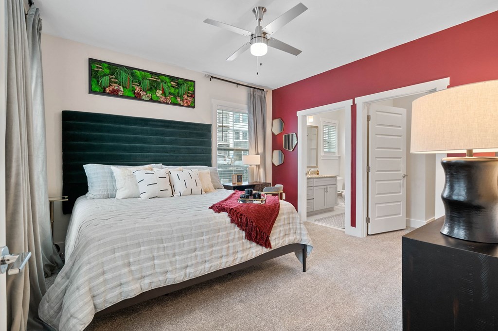a bedroom with a bed and a ceiling fan