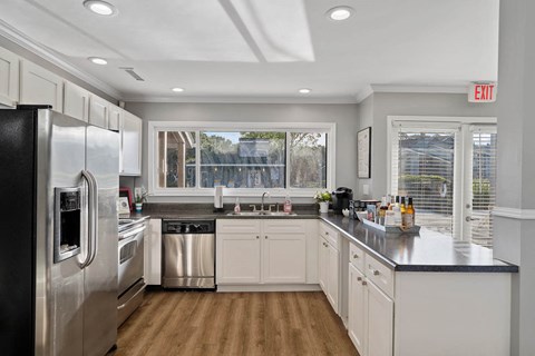 a kitchen with stainless steel appliances and white cabinets