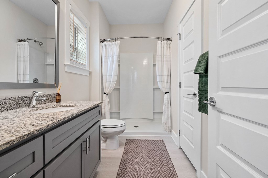 a bathroom with a sink and a toilet and a shower