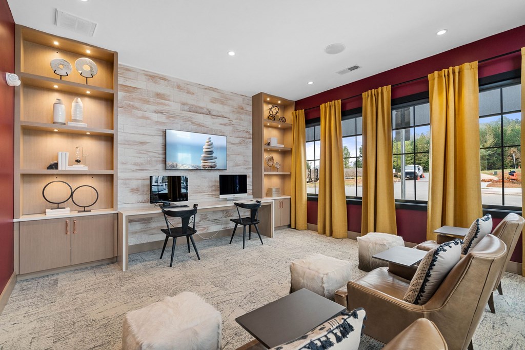 a living room with a couch and chairs and a tv