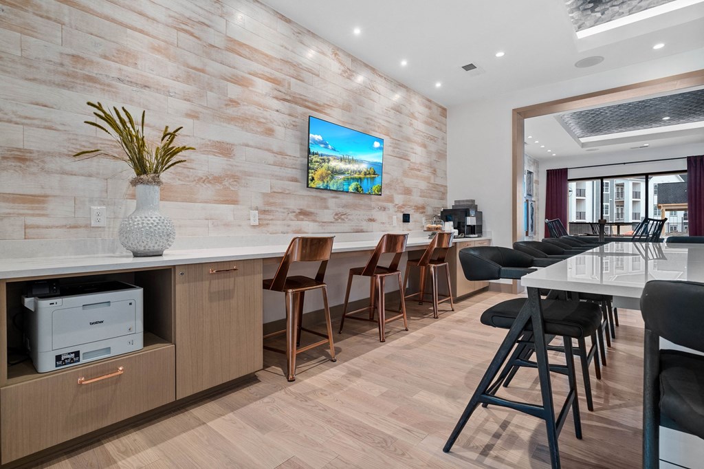 a bar with bar stools and a counter with chairs in front of a bar