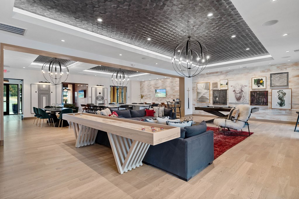 a large living room with a large table and chairs