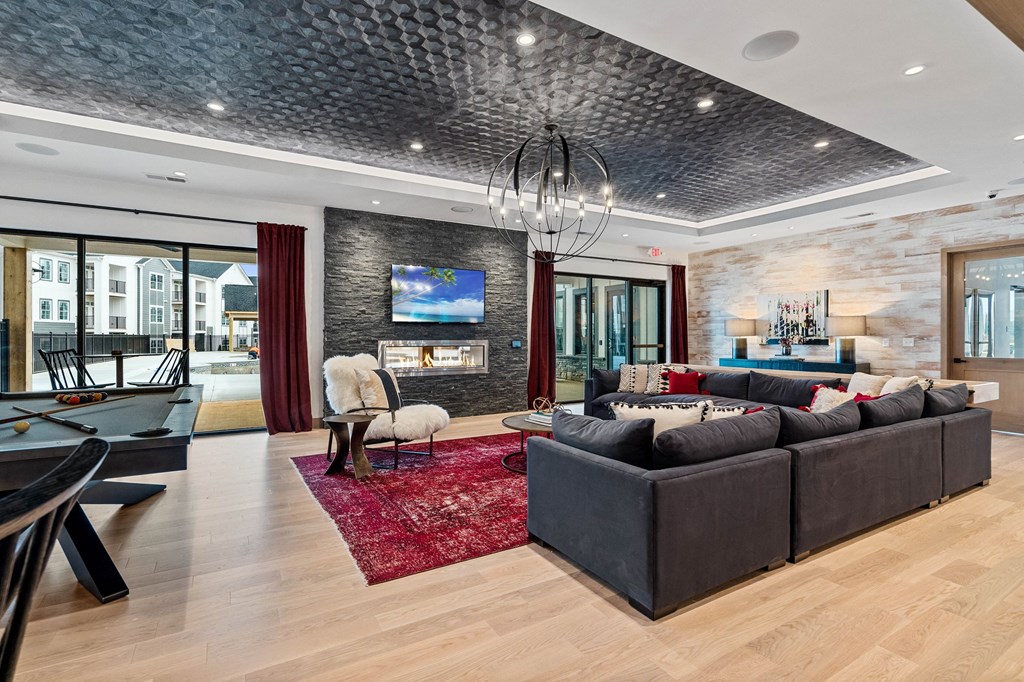 a living room with a couch and a table in front of a fireplace