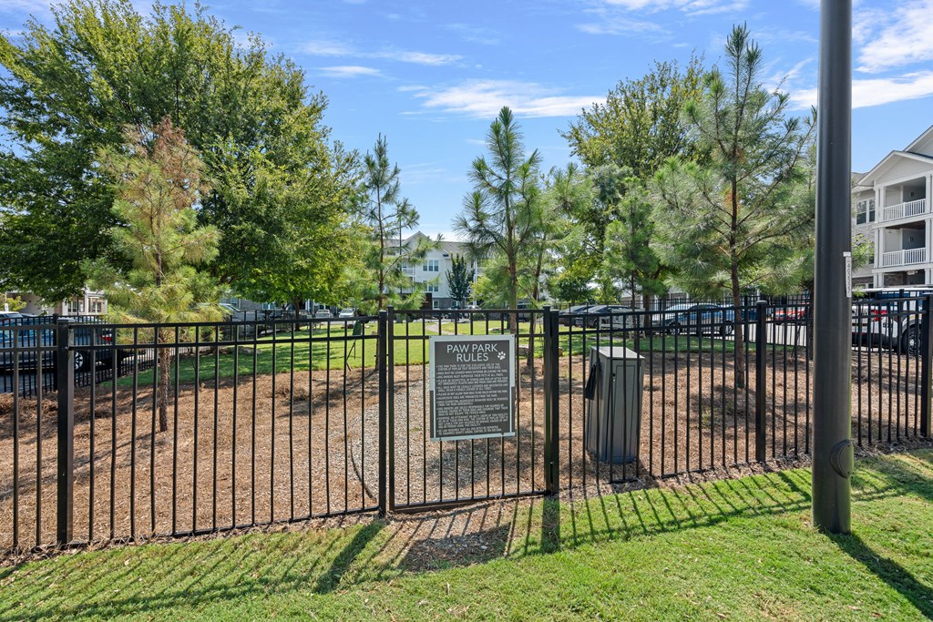 A sign in front of a fence reads "PAWELS PARK".