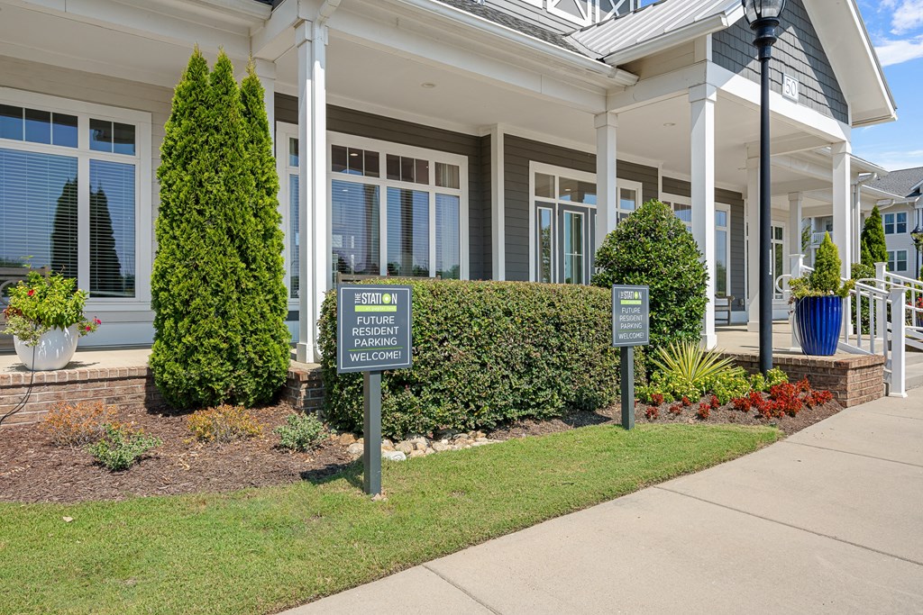 the front of a building with signs on the sidewalk