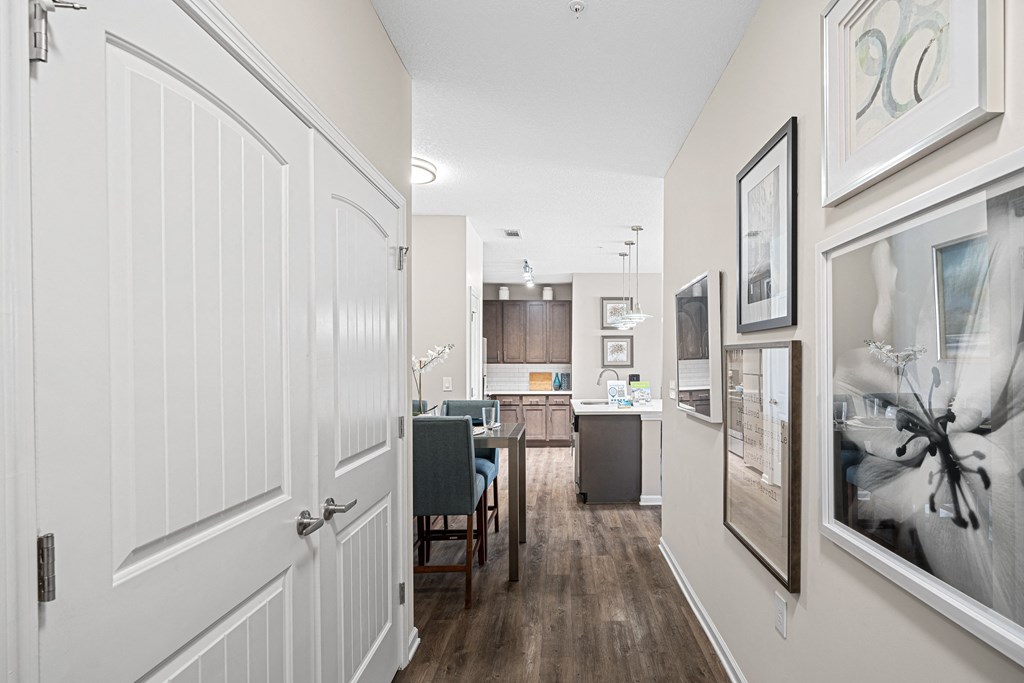a view of a kitchen and living room from a hallway