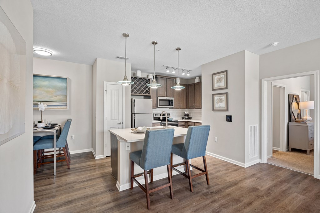 a kitchen and dining room with a table and chairs