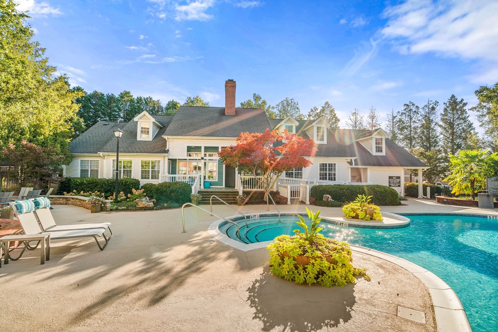 a swimming pool with a house in the background