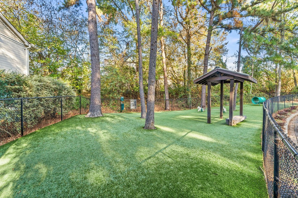 a backyard with a dog park and a gazebo
