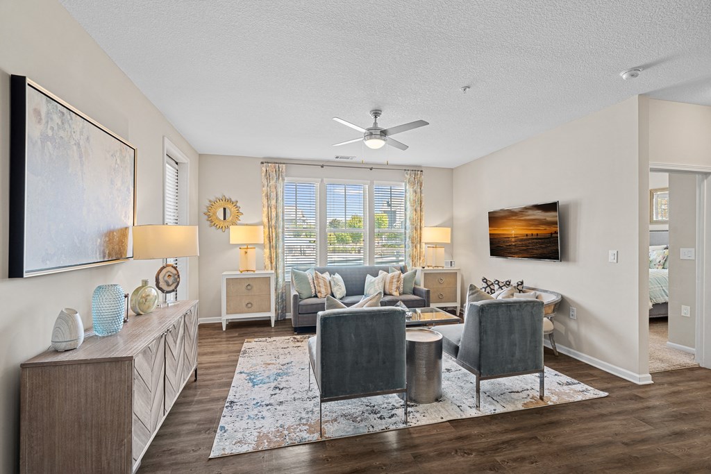 a living room with furniture and a ceiling fan