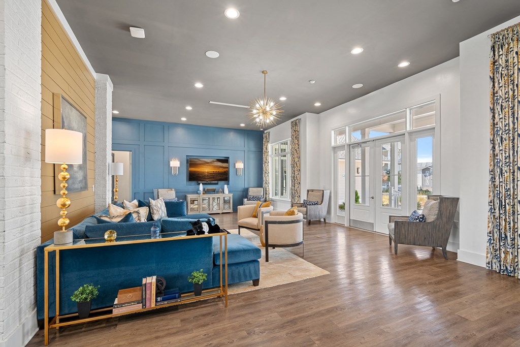 a living room with blue walls and a wood floor
